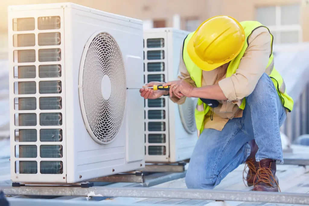 AC Technician repairing AC on roof