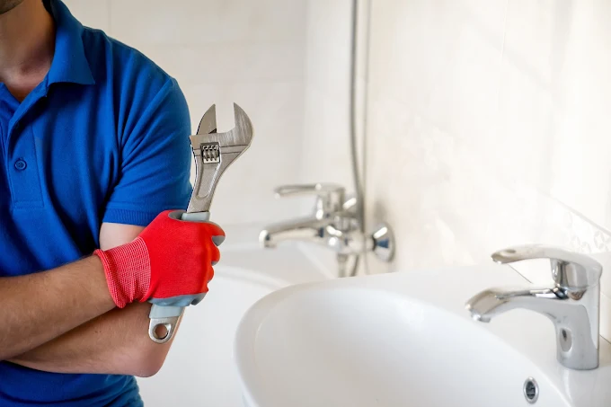 Plumber with wrench doing plumbing repair